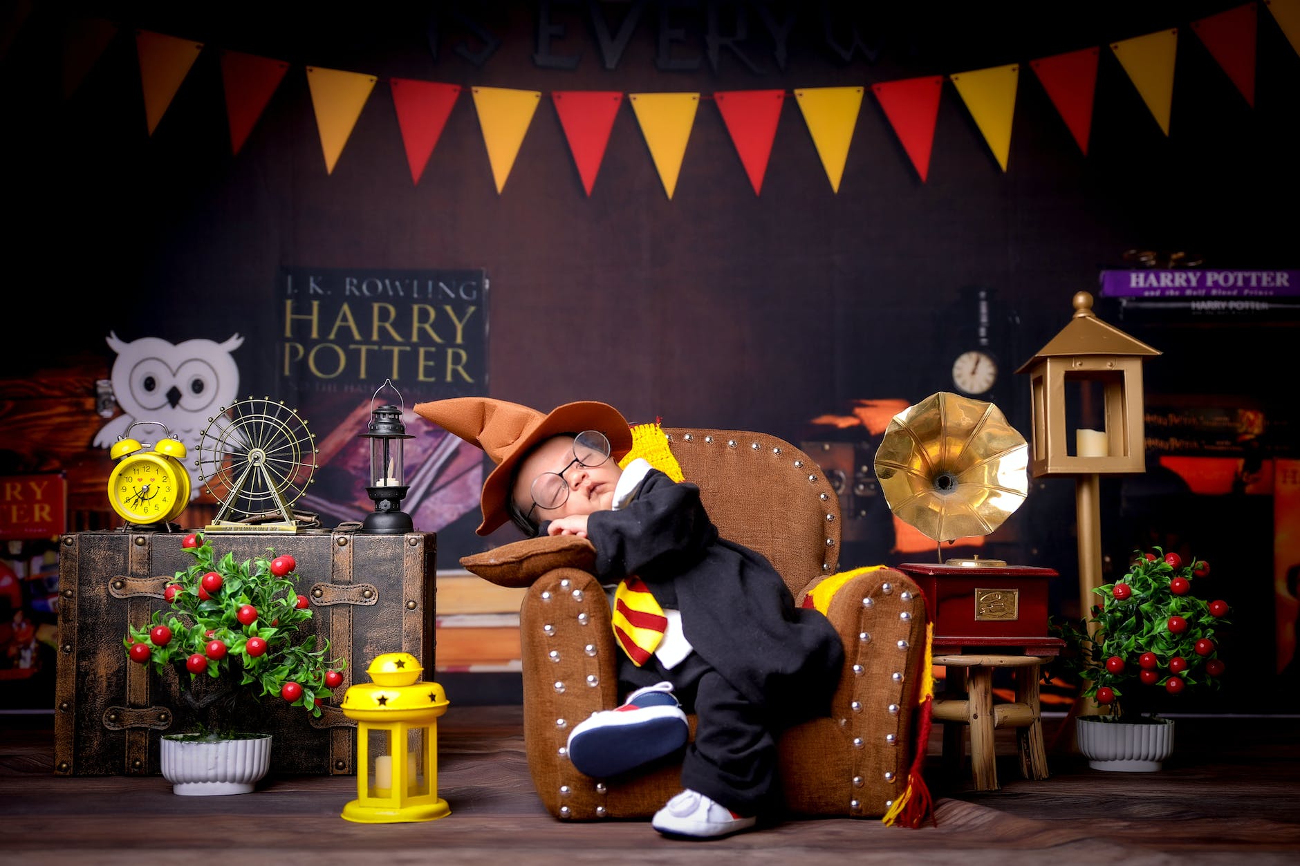 cute baby in costume sitting in chair in decor