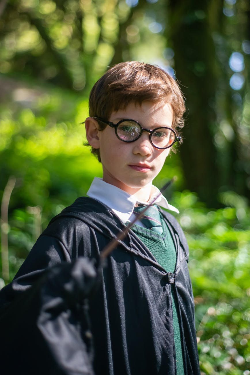 boy in black framed eyeglasses holding a wand