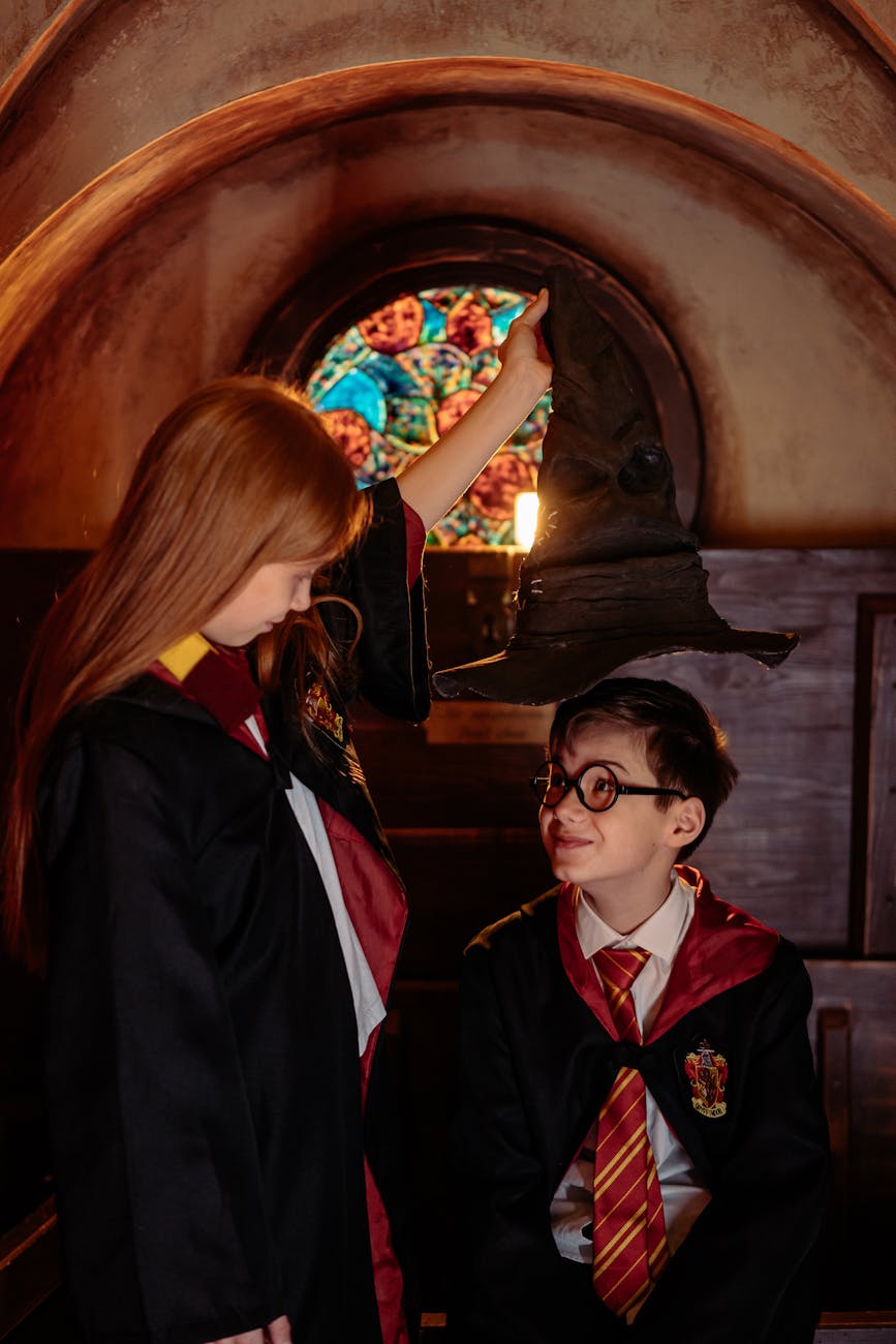 a girl and boy wearing a harry potter costumes