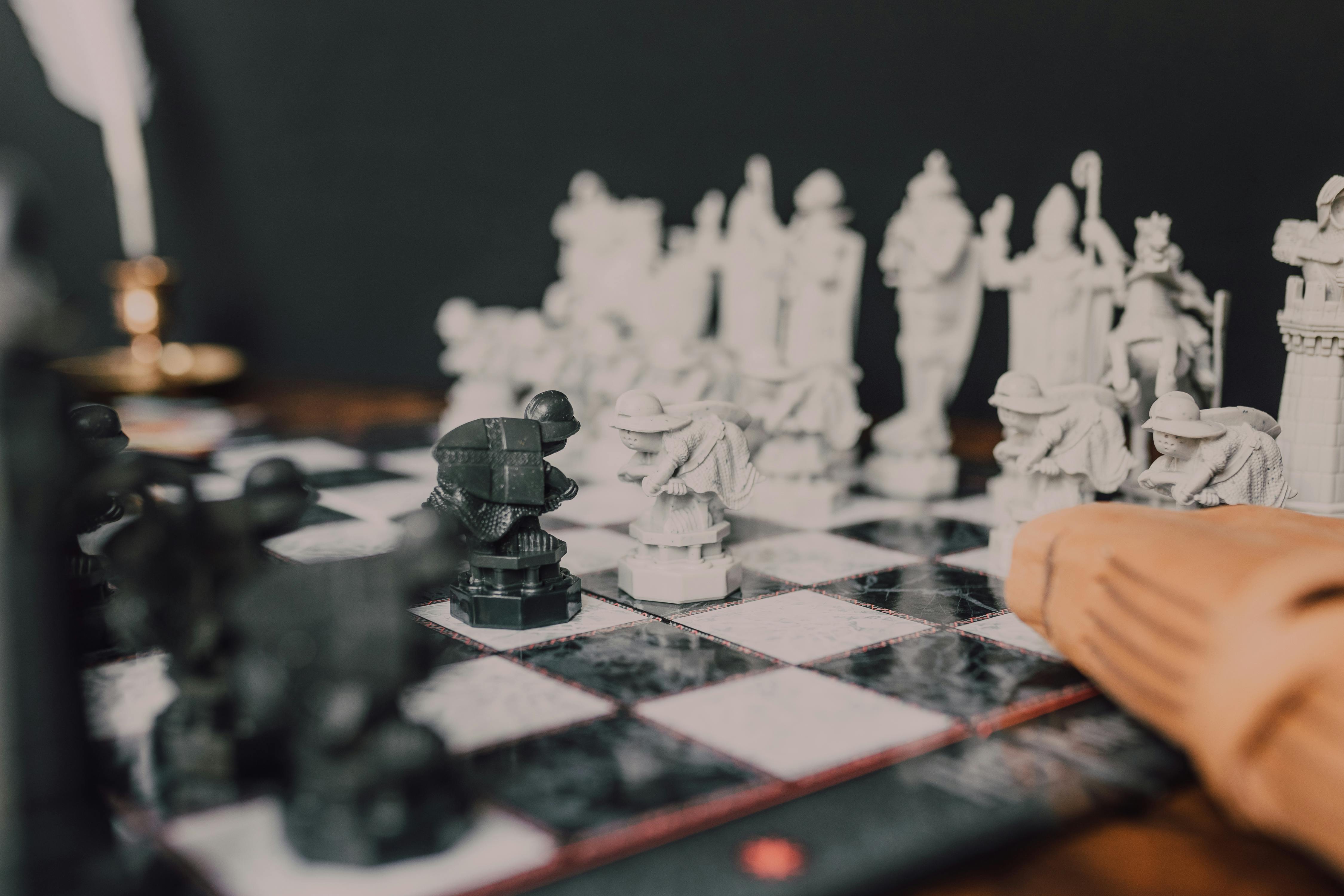 Intricate chess pieces inspired by wizarding themes on a chessboard.